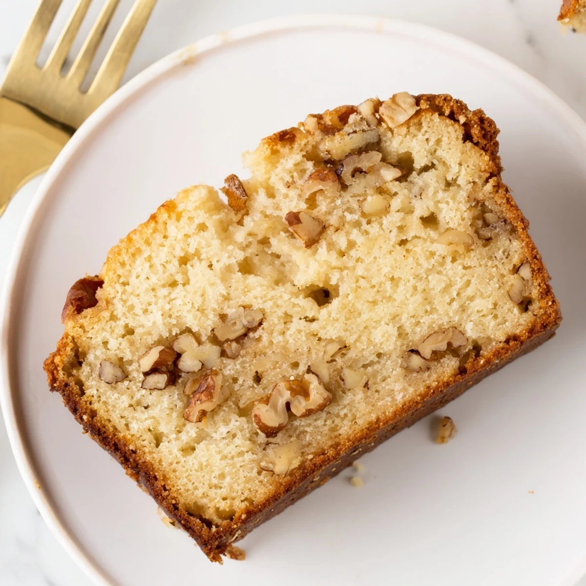 Freshly baked ultimate banana nut bread cooling on a wire rack with golden crust