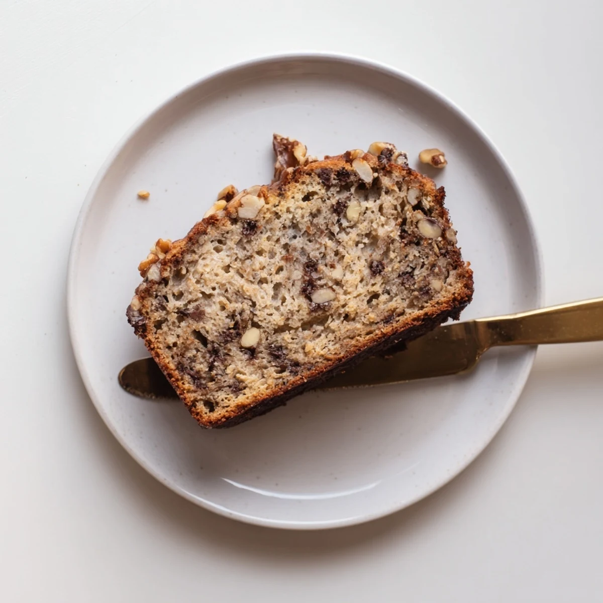 Moist best ever banana bread slice revealing tender crumb with melted butter