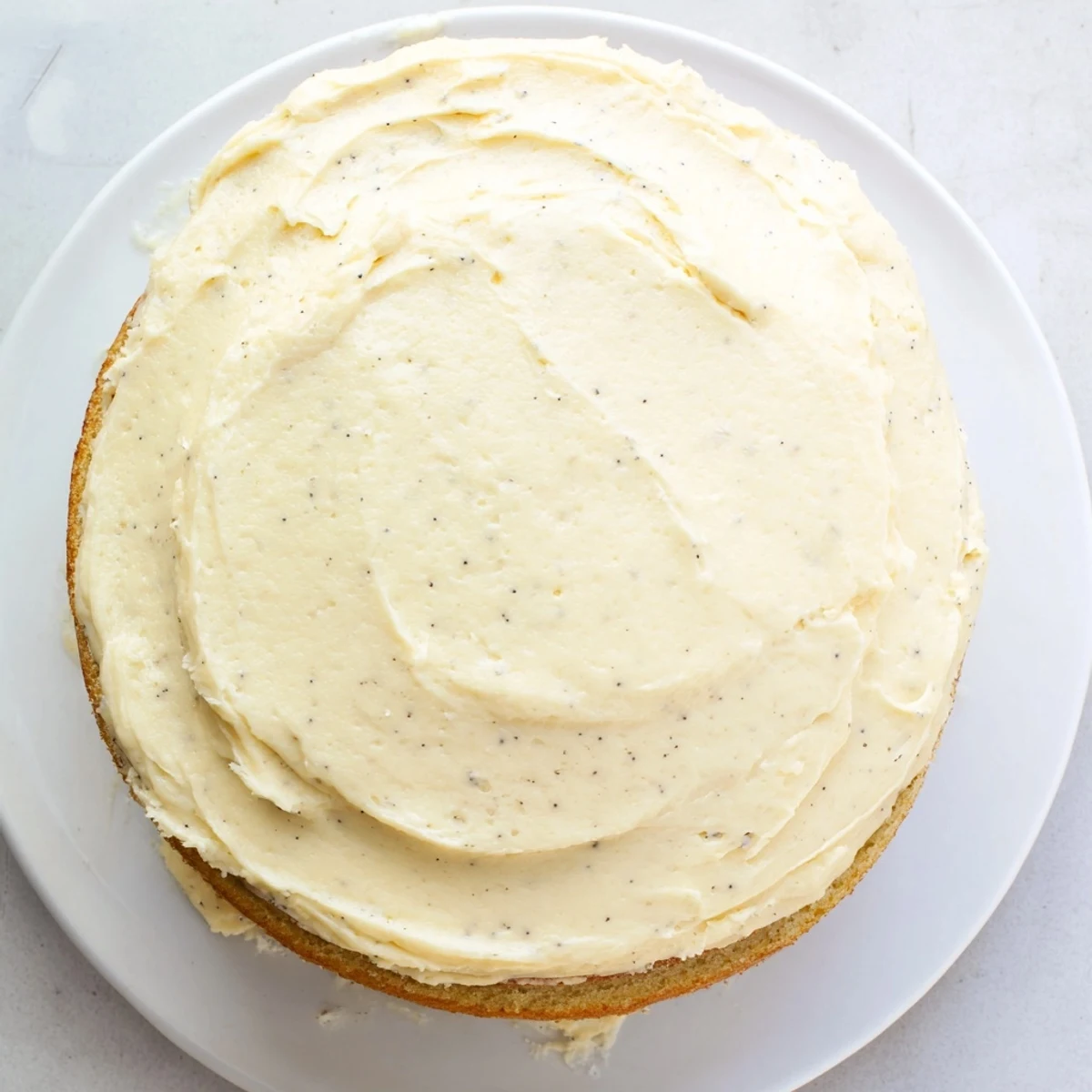 Slice of vanilla bean birthday cake showing tender crumbs and thick buttercream frosting between layers