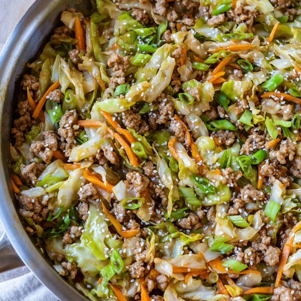 One-skillet egg roll in a bowl features tender pork, colorful cabbage, and carrots in a gluten-free Asian-inspired meal