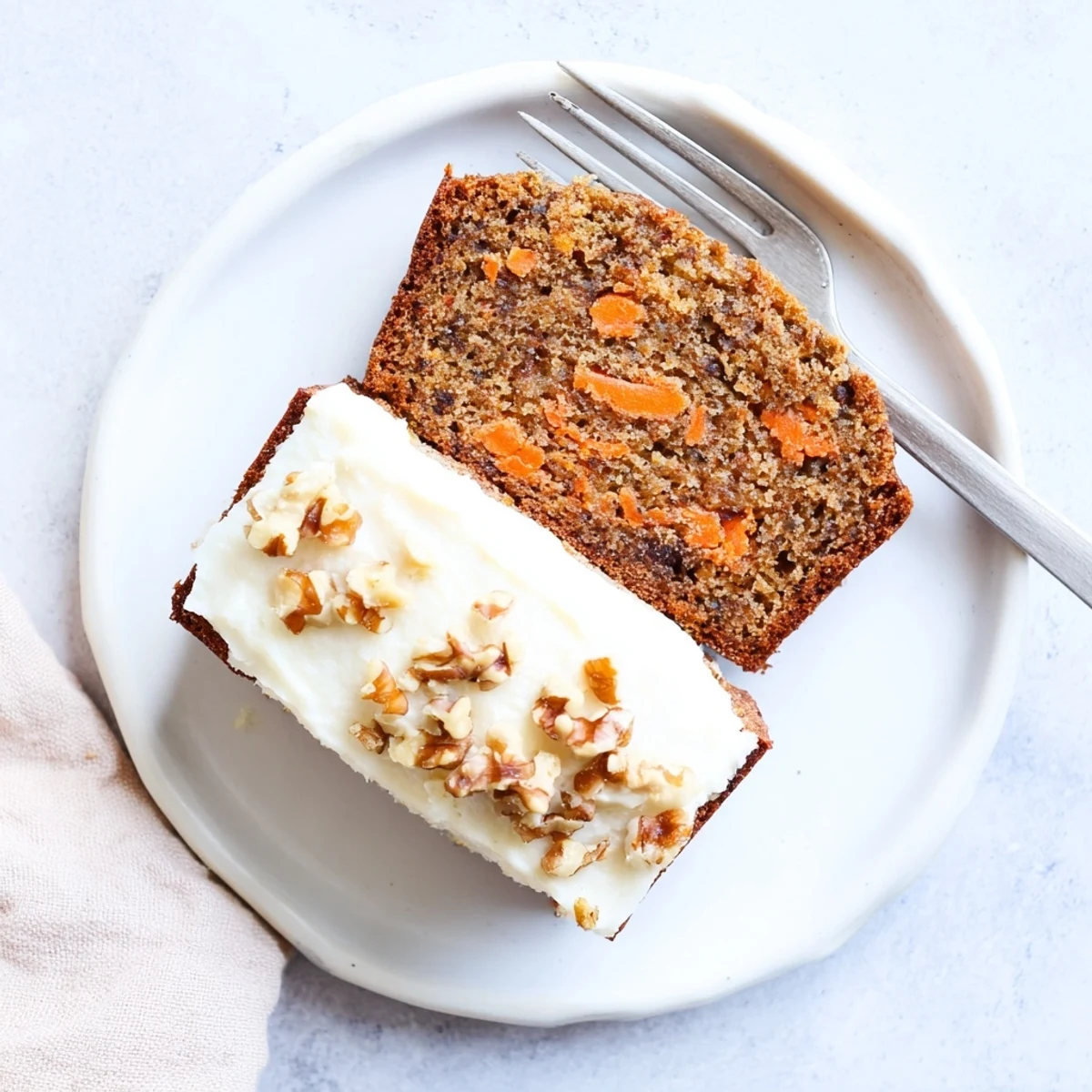 Freshly baked carrot cake banana bread cooling on a wire rack with visible grated carrot flecks
