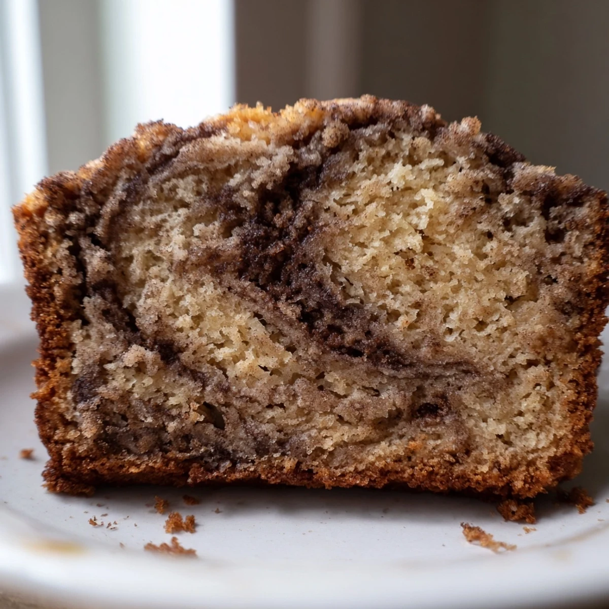 Cinnamon Sugar Swirl Banana Bread with golden crust and marbled cinnamon ribbon throughout moist crumb
