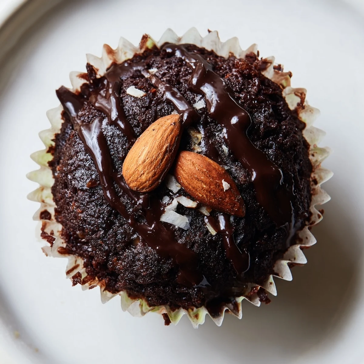 Decadent flourless almond joy cupcakes with gooey coconut centers on a rustic wire rack