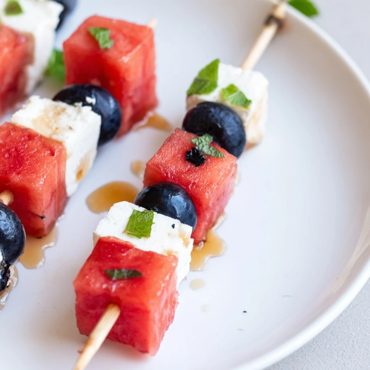 Easy Patriotic Watermelon Feta Skewers threaded on toothpicks, crisp, sweet, tangy bites.