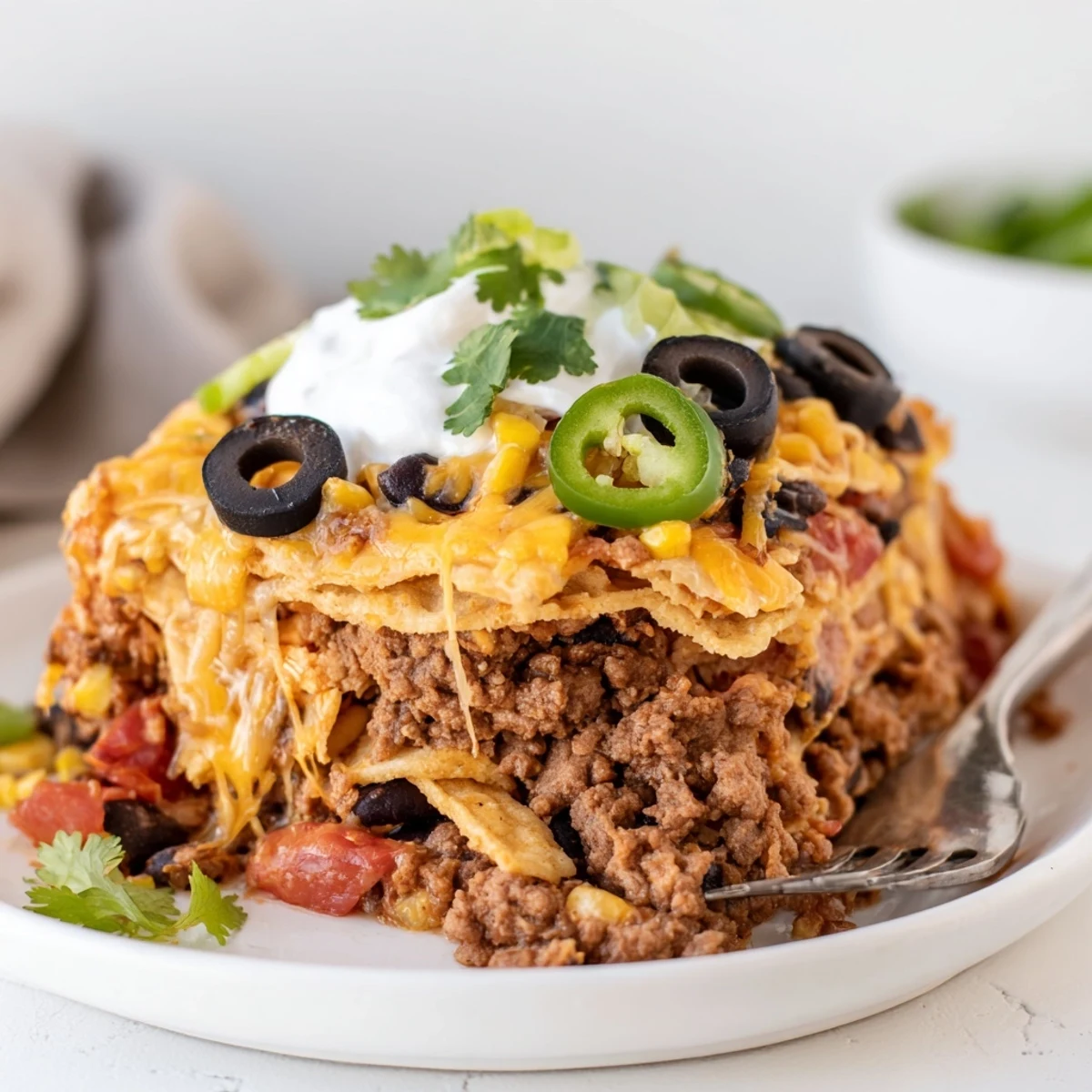 Cheesy Nacho Casserole bubbling golden, layered chips, seasoned beef, melted cheese