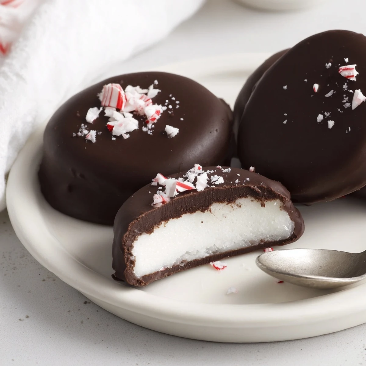 Homemade Peppermint Patties chilled, creamy center contrasted with firm chocolate exterior