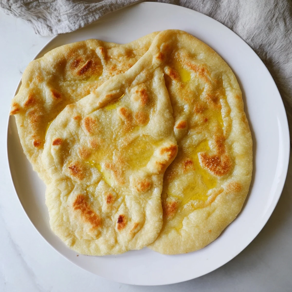 Golden Turkish Bazlama flatbread with soft pillowy texture and charred surface spots