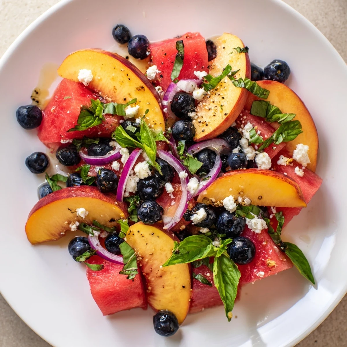 Peach Watermelon Salad With Feta, vibrant bowl of juicy fruit and crumbled cheese.