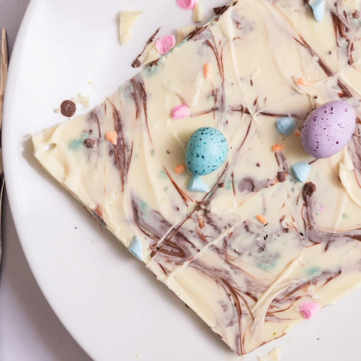 Stacked Robin Egg Easter Bark on parchment, sweet creamy white and milk chocolate