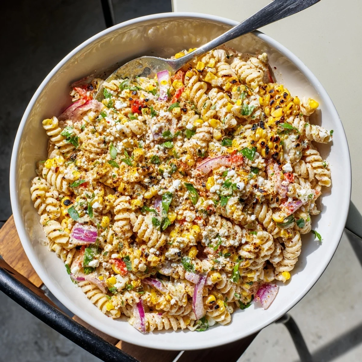 Smoky grilled corn and tender fusilli coated in tangy lime dressing in this Elote Street Corn Pasta Salad