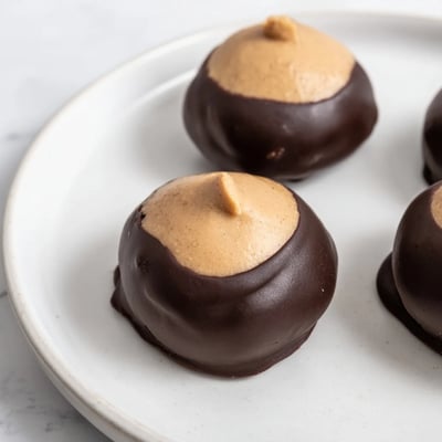 Creamy peanut butter buckeye cookies partially dipped in rich melted semisweet chocolate